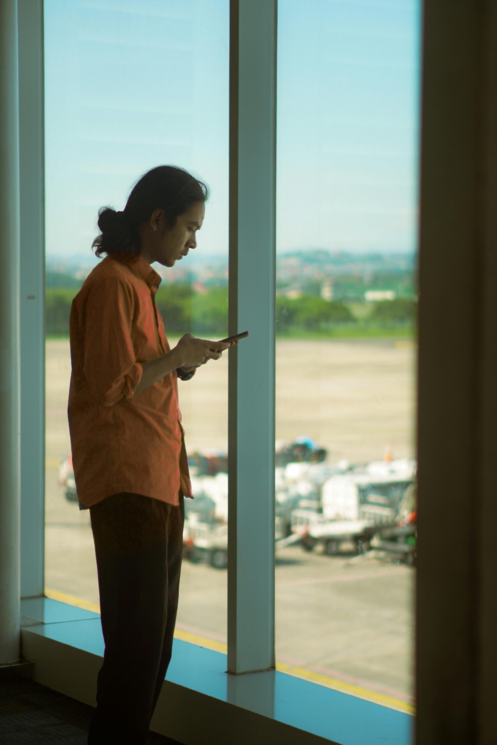 Traveler at airport with smartphone